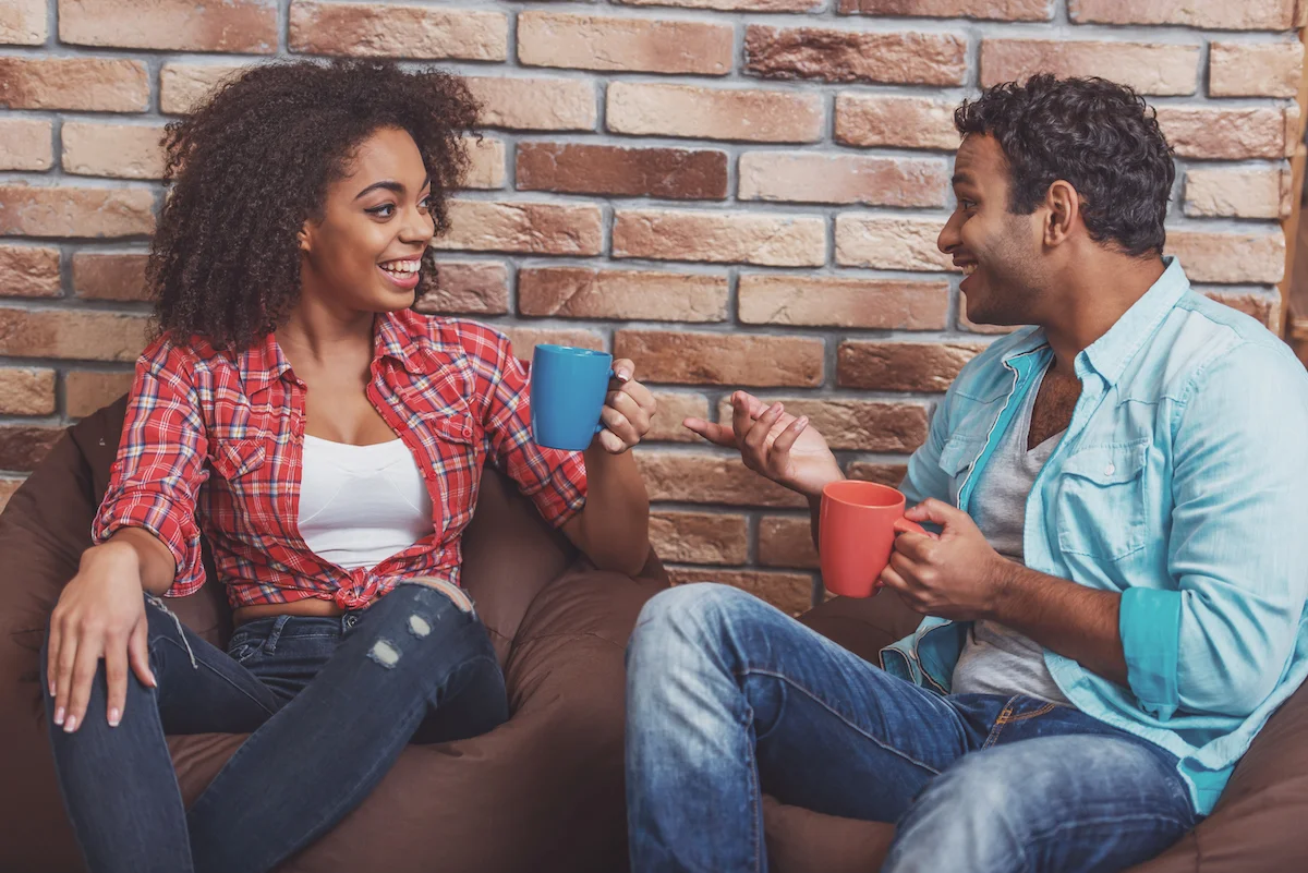 man and woman having coffee and talking about their relationship