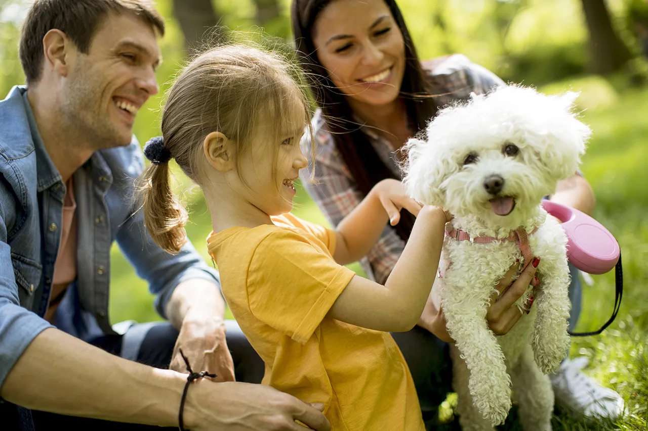 Happy Family interacting with pet dog