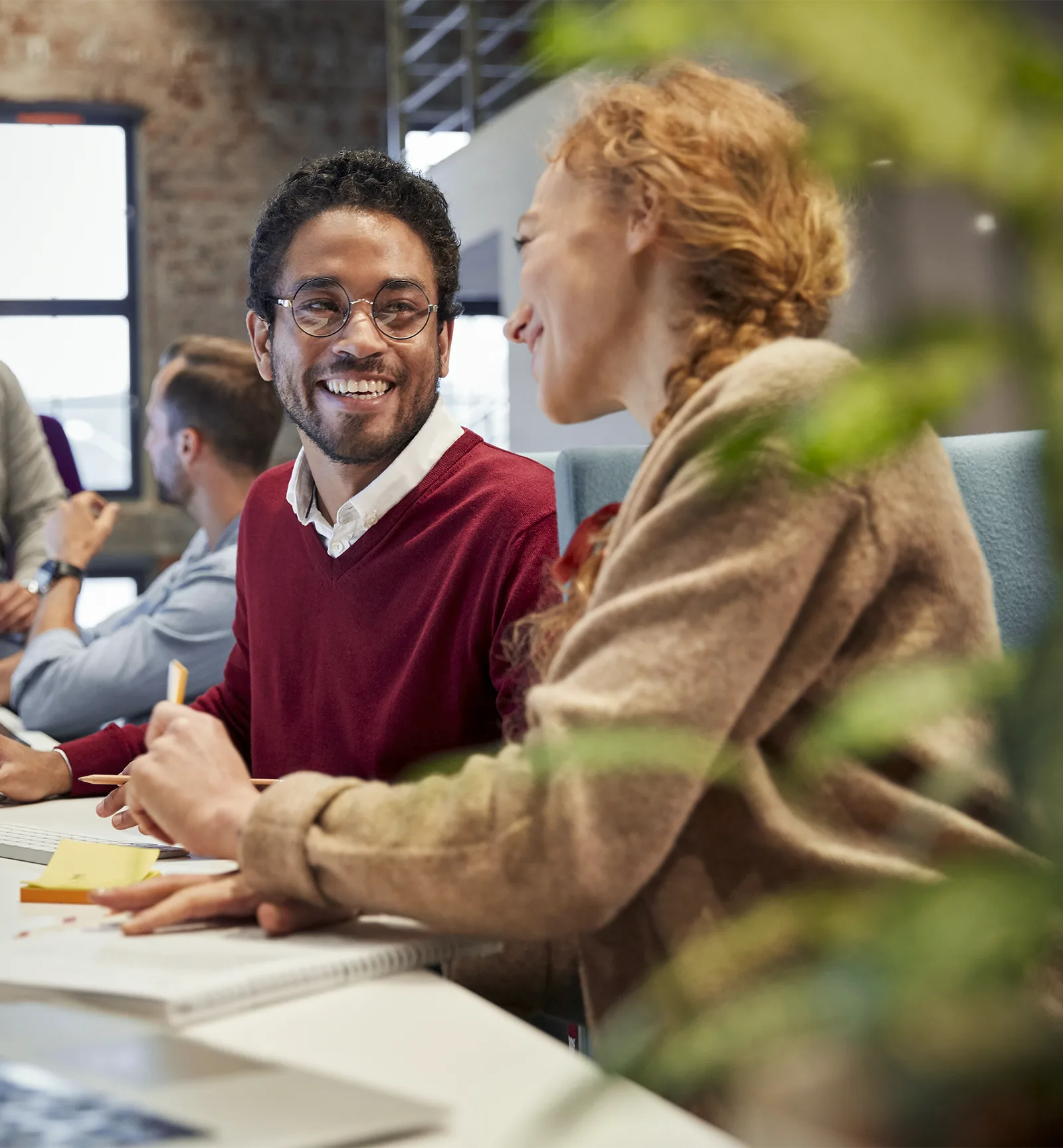 smiling worker collaborating with co-worker